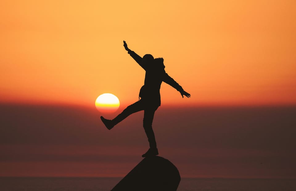 My Story - person on a rock at sunset